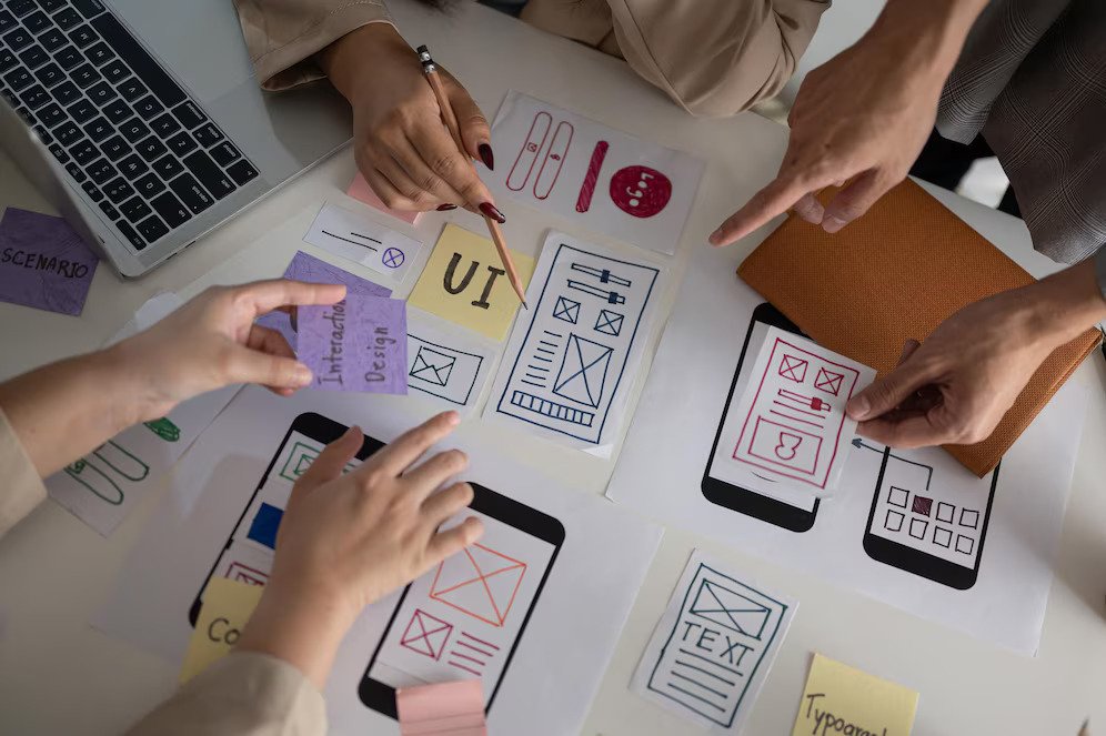 top-view-image-ux-ui-graphic-designer-team-voting-perfect-prototype-meeting_67155-43046